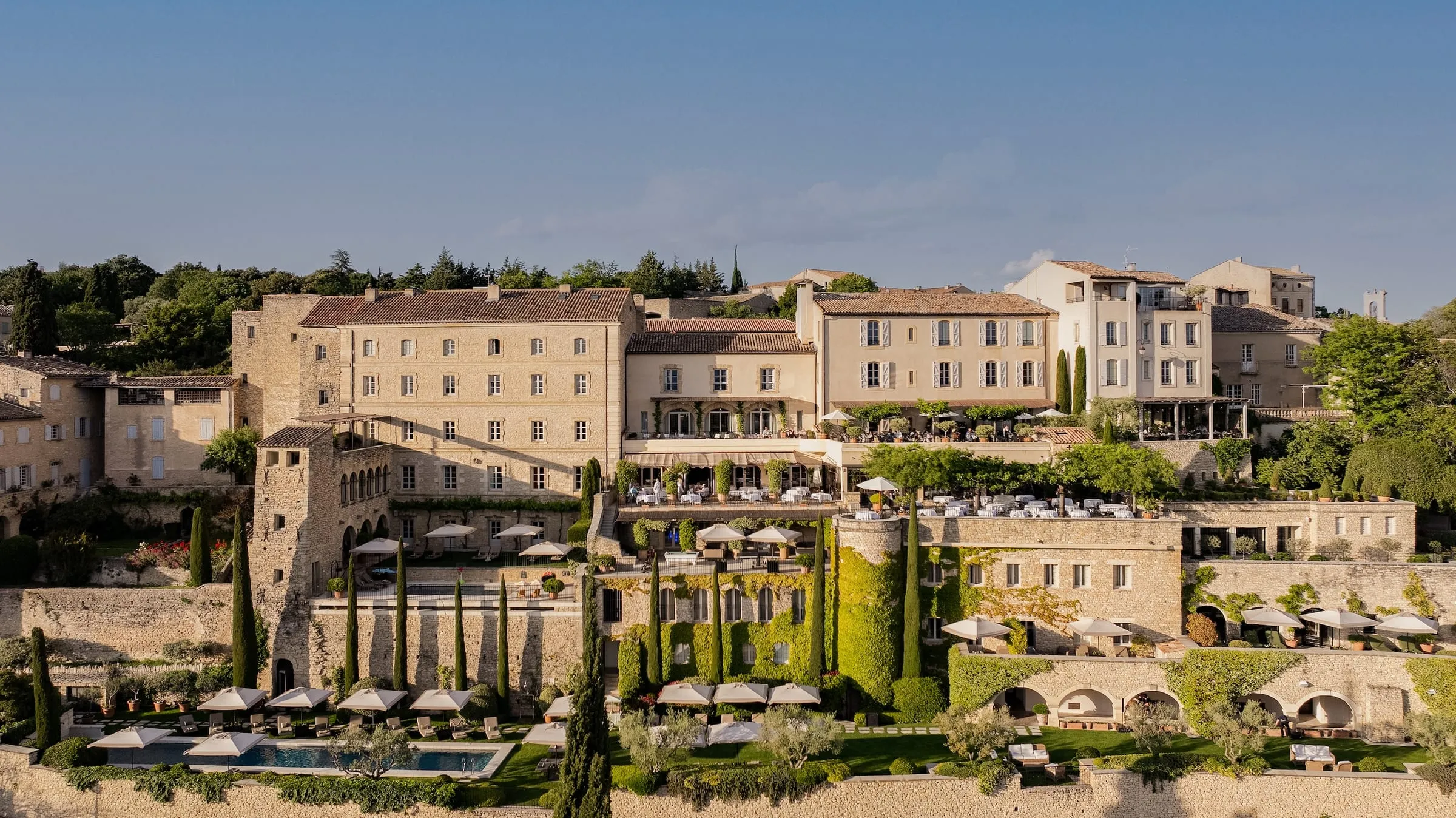 The stone terraces of Airelles Gordes, La Bastide, built into the ramparts of the hilltop village of Gordes above the Luberon valley