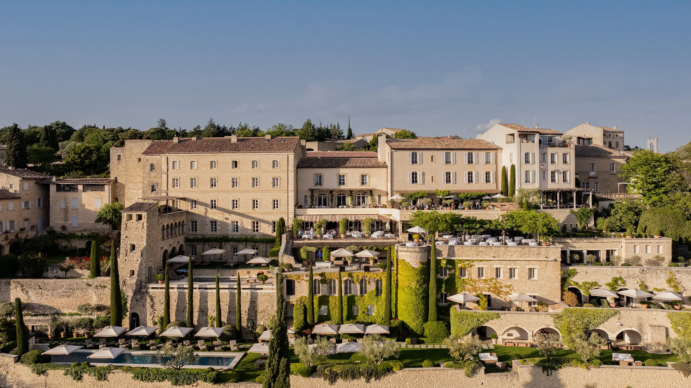 The stone terraces of Airelles Gordes, La Bastide, built into the ramparts of the hilltop village of Gordes above the Luberon valley
