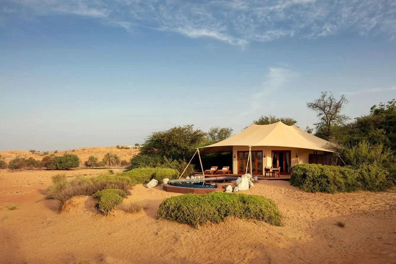 A freestanding, Bedouin-tent-inspired suite at Al Maha set among the dunes of the Dubai Desert Conservation Reserve