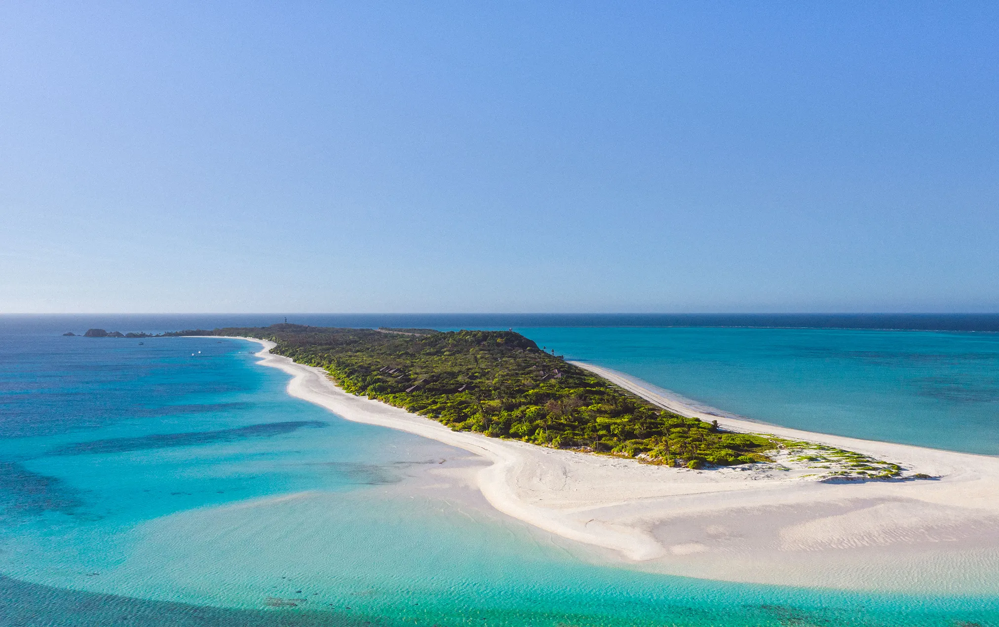 Aerial view of Pamalican Island's turquoise reef and the small aircraft runway that serves Amanpulo