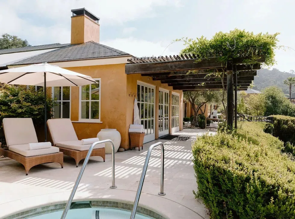 A treatment room at The Spa at Auberge du Soleil, with indoor-outdoor access and views over the olive grove