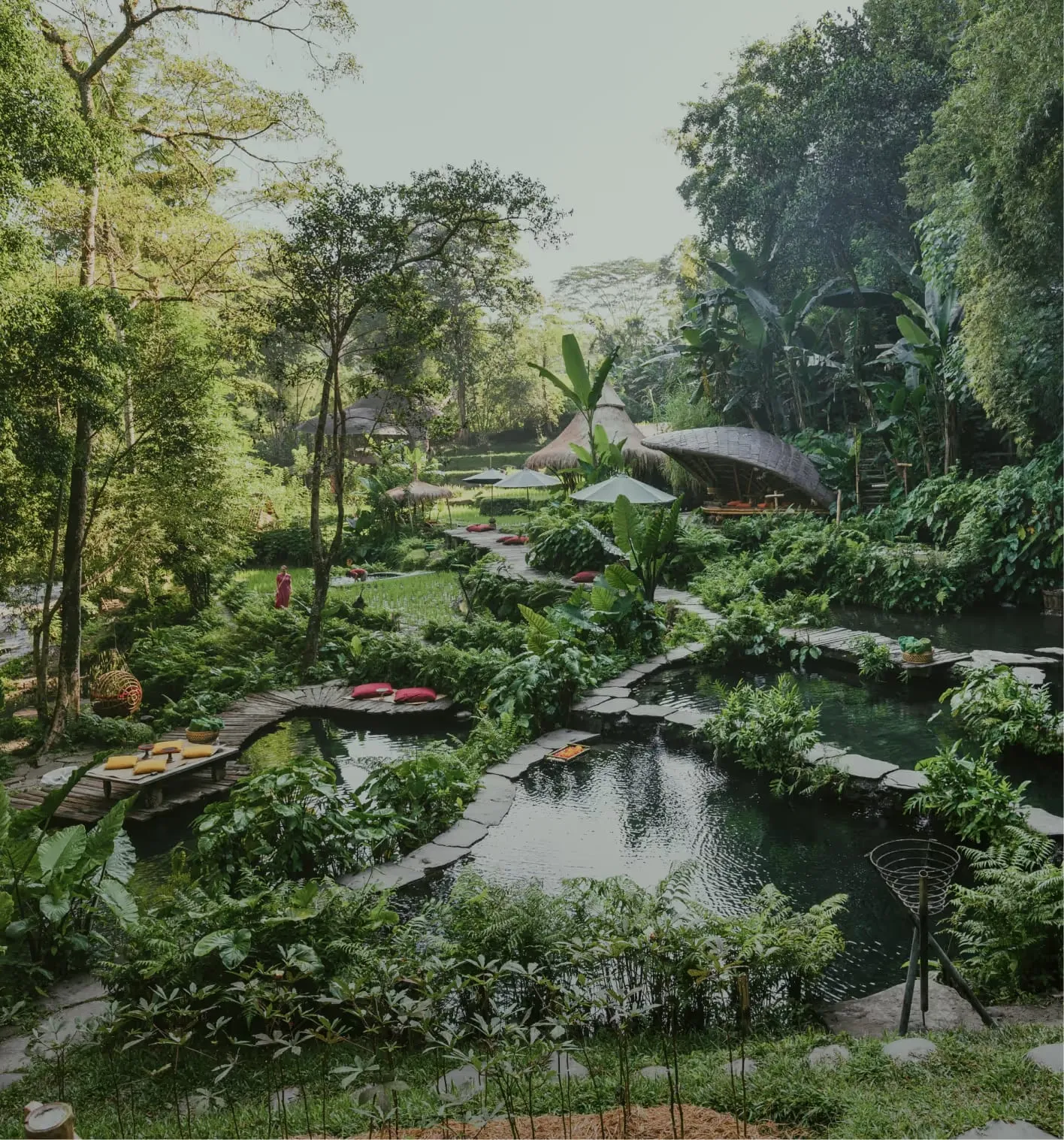 Spring-fed natural swimming pool built into volcanic rock beside the Ayung River