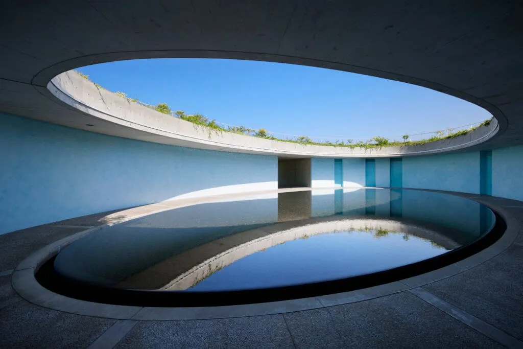 Exposed concrete corridor and atrium inside Benesse House Museum designed by Tadao Ando