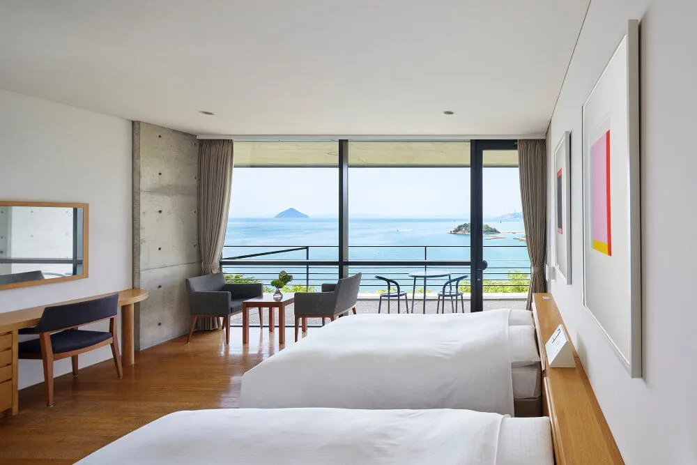 The concrete form of Benesse House Museum by Tadao Ando set into a hillside above the Seto Inland Sea on Naoshima