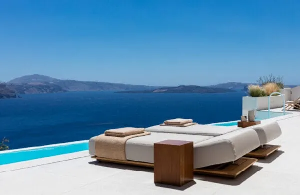 A private infinity pool at Canaves Oia Suites overlooking the Santorini caldera and volcano