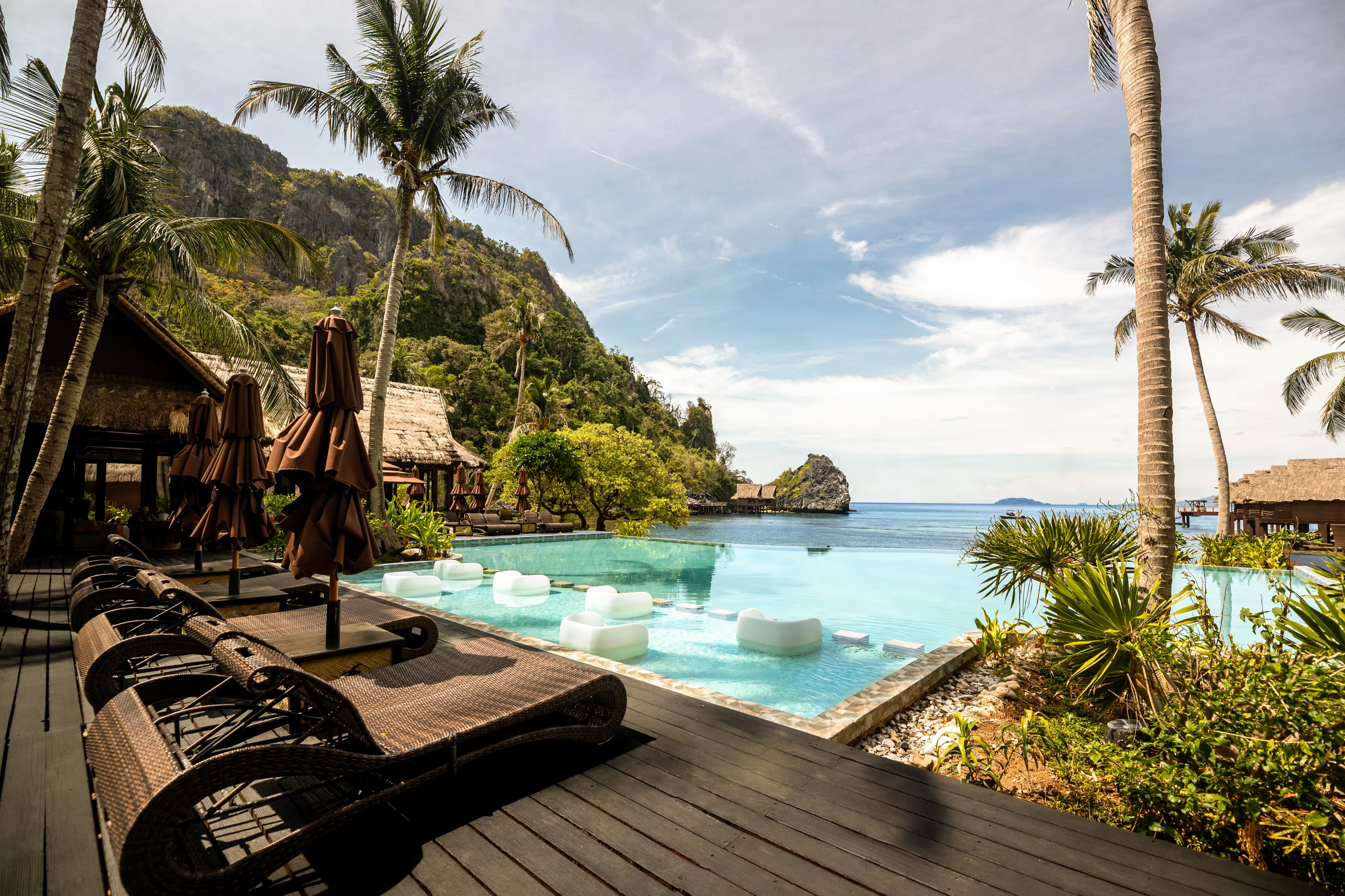 The infinity pool at Cauayan Island Resort meeting the horizon of Bacuit Bay