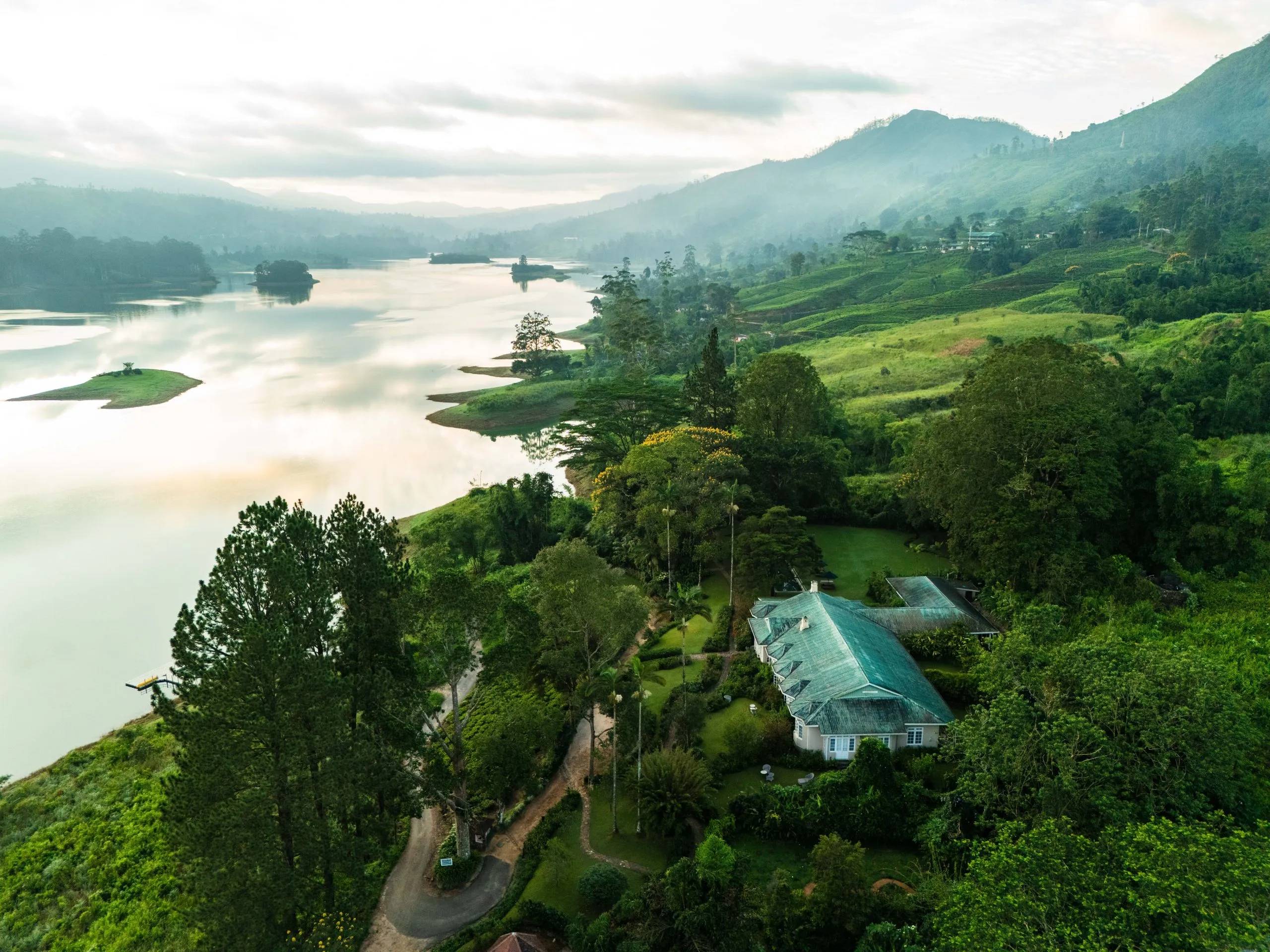 A colonial-era planter's bungalow overlooking terraced tea fields at Ceylon Tea Trails in Sri Lanka's hill country
