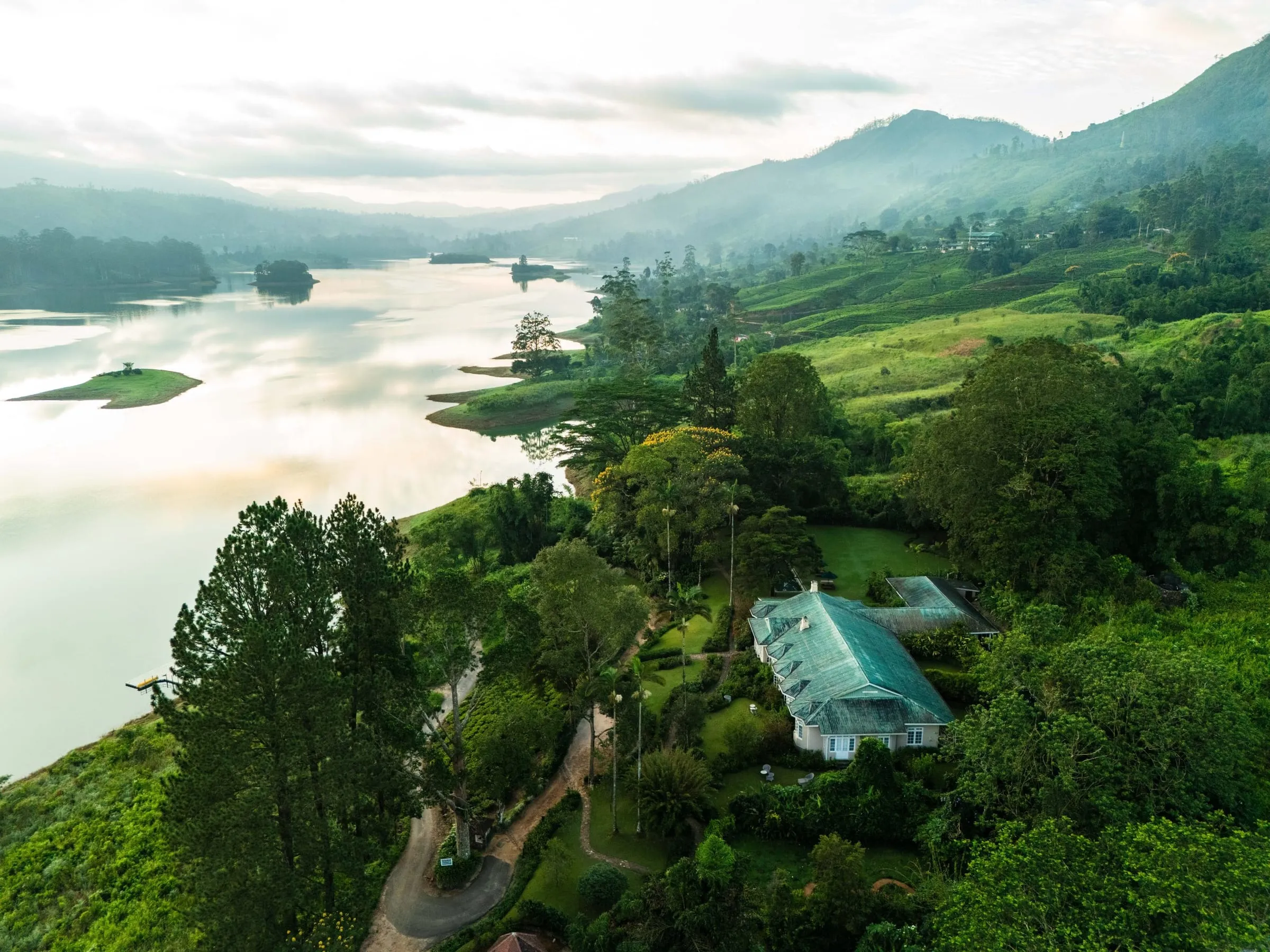 A colonial-era planter's bungalow overlooking terraced tea fields at Ceylon Tea Trails in Sri Lanka's hill country