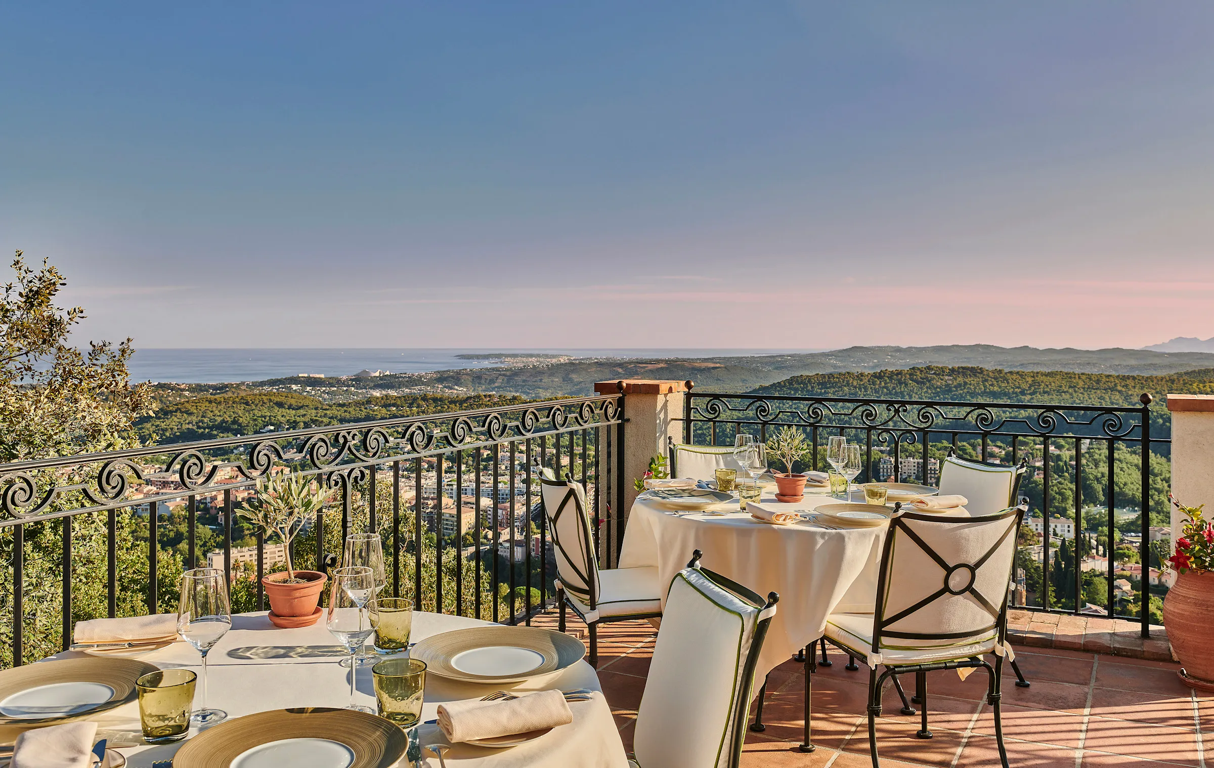 Interior of a suite at Chateau Saint-Martin with Provençal-style furnishings, warm stone walls and a view over the gardens