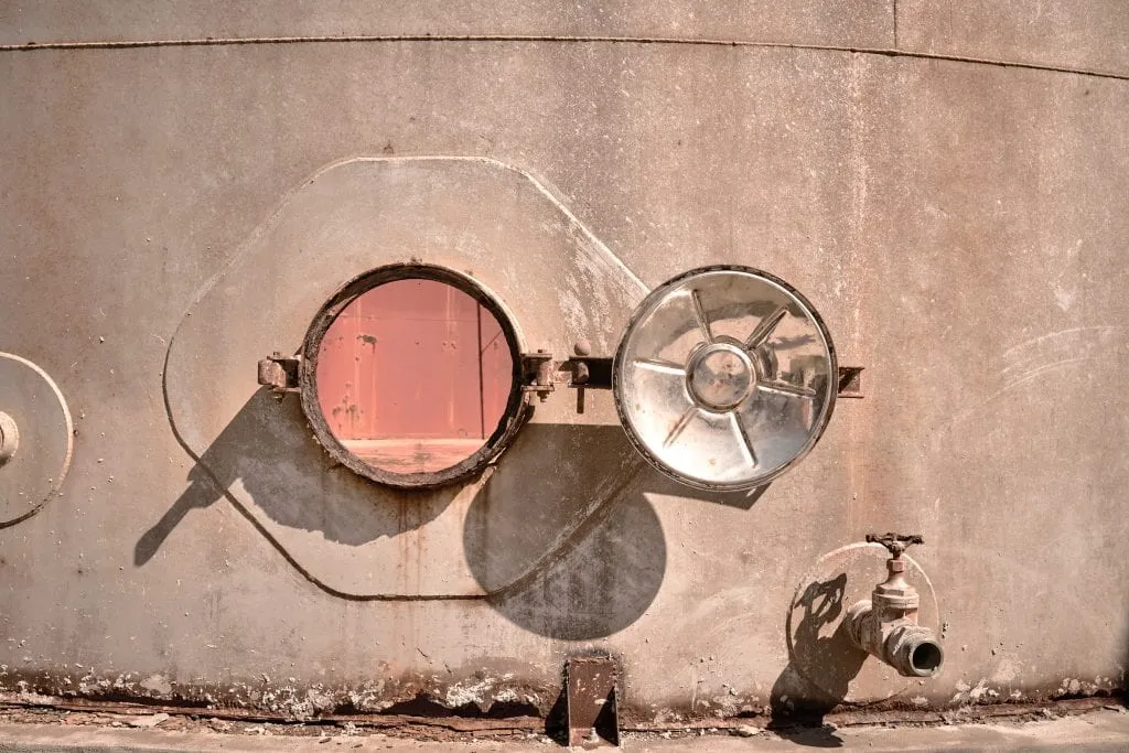 A Beachfront WineTank Suite at Dexamenes with its concrete shell cut open toward the Ionian Sea