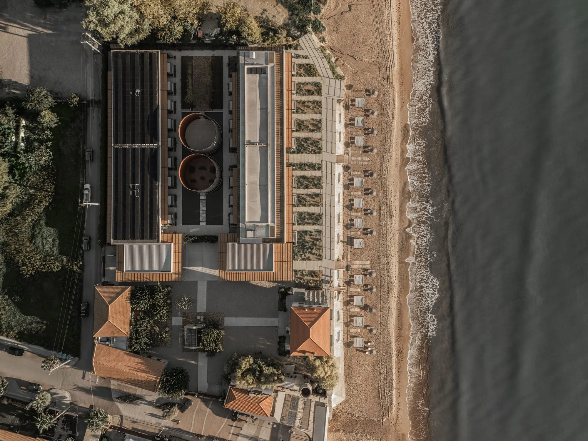 Rows of converted concrete wine-fermentation tanks facing the sea at Dexamenes Seaside Hotel on Kourouta beach, Peloponnese