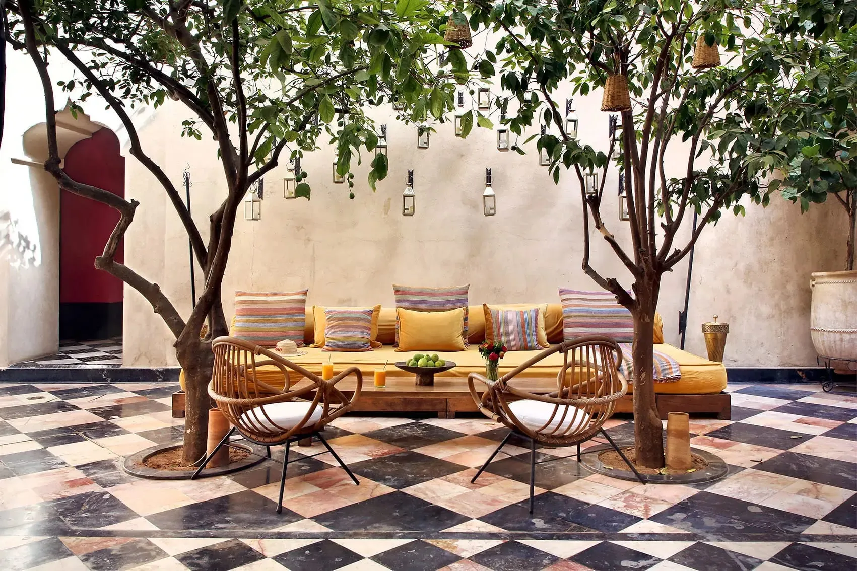 A courtyard at El Fenn hotel in the Marrakech medina, with traditional zellige tilework and contemporary art