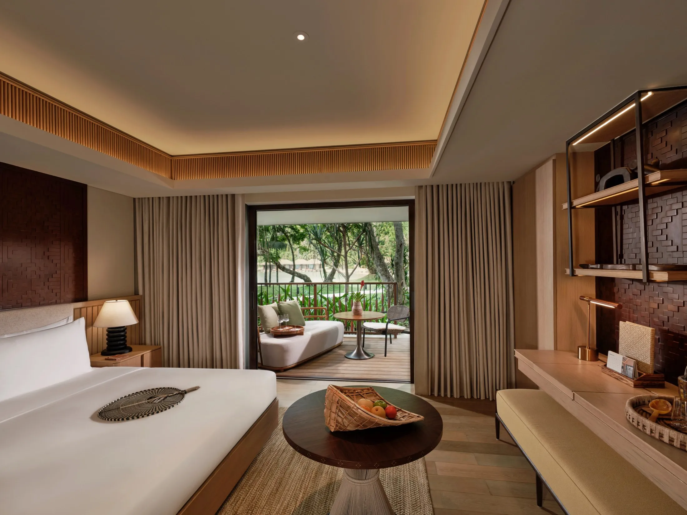 A Forest Room interior at Lagen Island Resort with timber panelling and floor-to-ceiling windows facing the tree canopy