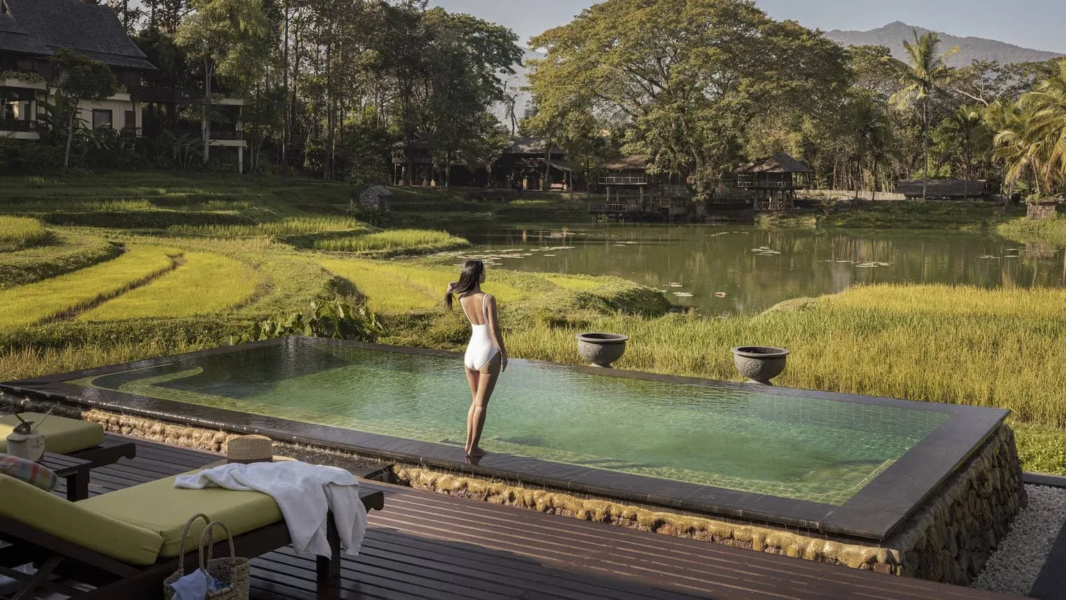 Teak Lanna-style pavilions overlooking terraced rice paddies in the Mae Rim valley at Four Seasons Resort Chiang Mai