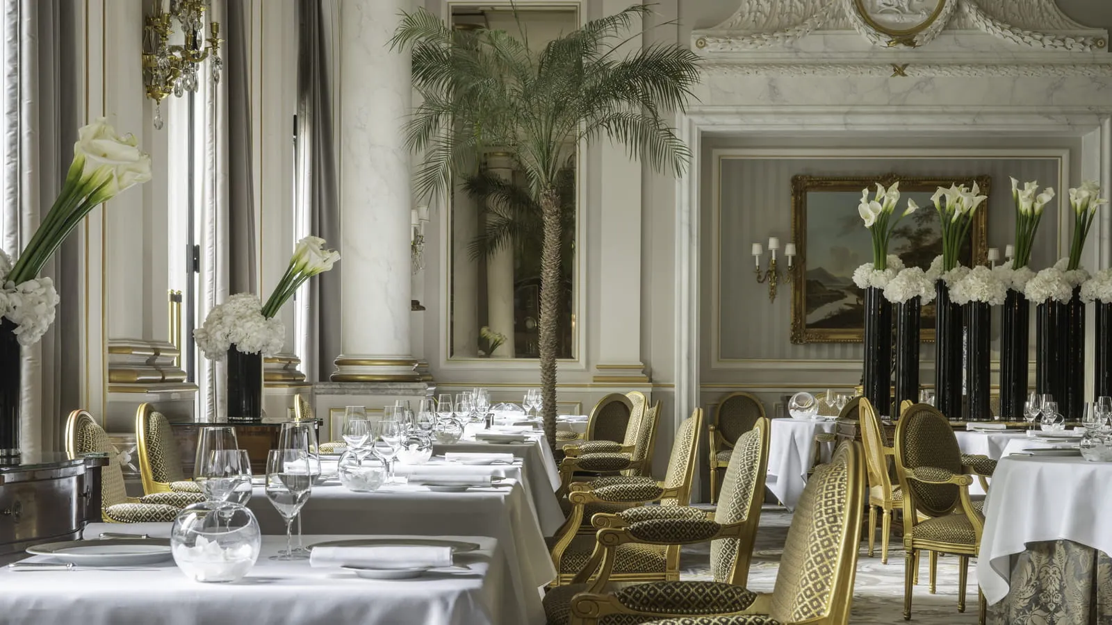 A renovated guest suite at Four Seasons Hotel George V styled as a Parisian apartment with parquet flooring