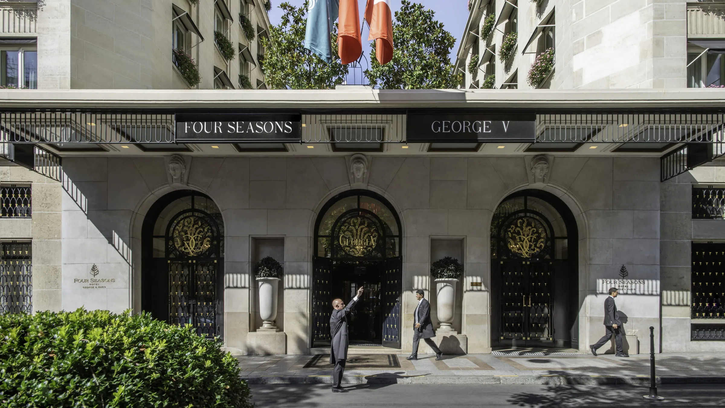 The Art Deco facade of Four Seasons Hotel George V on Avenue George V in Paris, illuminated at dusk