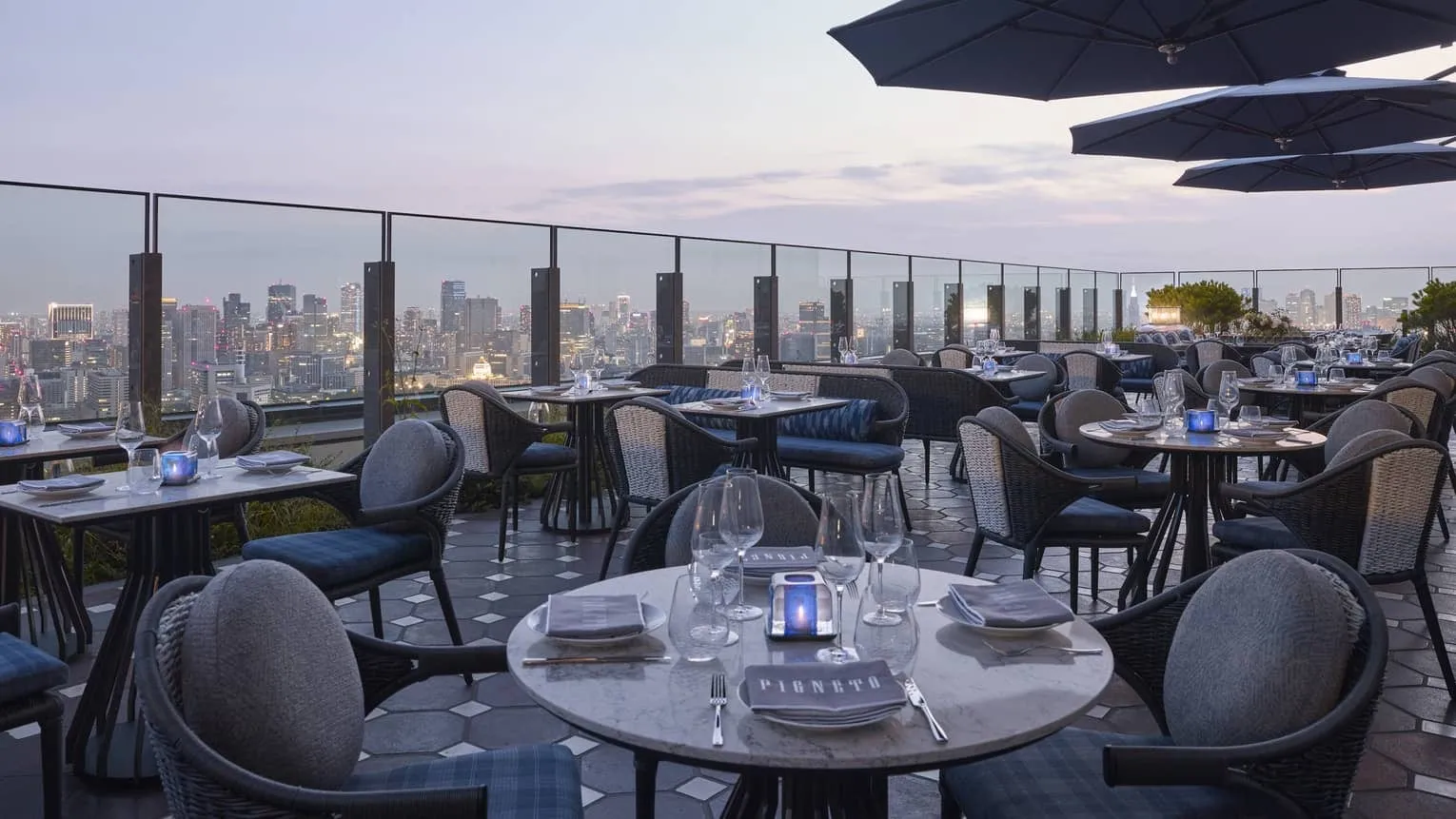 The dining room at est, the hotel's Michelin-starred restaurant on the 39th floor, set with contemporary French tableware