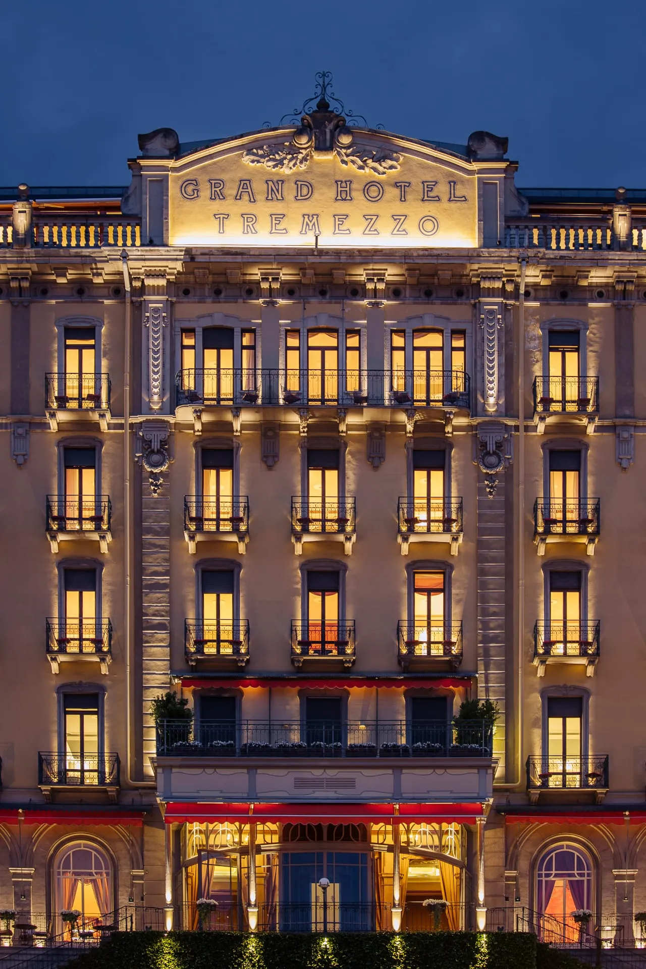 The Belle Époque facade of Grand Hotel Tremezzo overlooking Lake Como, with the Grigne mountains and Bellagio across the water