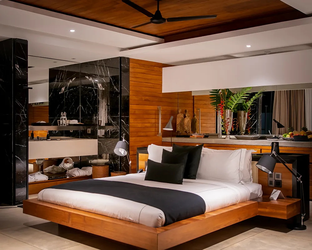 Private saltwater plunge pool on the terrace of a one-bedroom villa, screened by forest planting