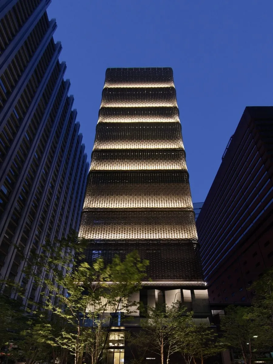 The Edo Komon lattice facade of Hoshinoya Tokyo rising above the Otemachi financial district