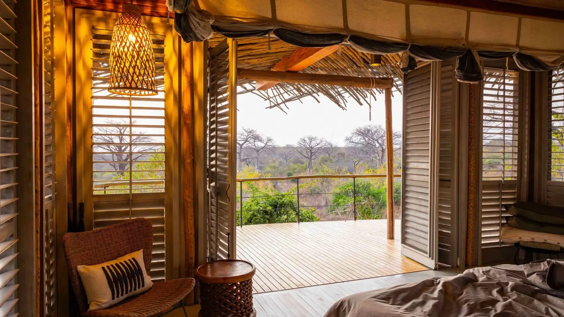 The rim-flow infinity pool at Jabali Ridge set among granite boulders with views over the Ruaha landscape