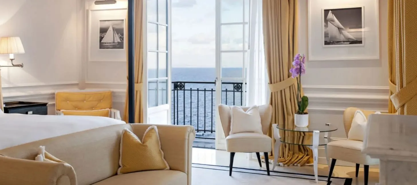 A guest room at JK Place Capri decorated in navy and white with yacht-inspired detailing