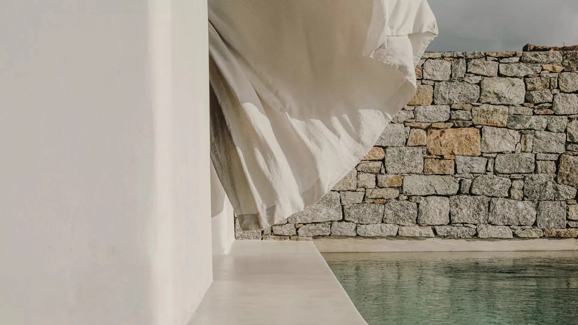 A private heated pool and terrace outside a Kalesma Suite overlooking the Aegean Sea