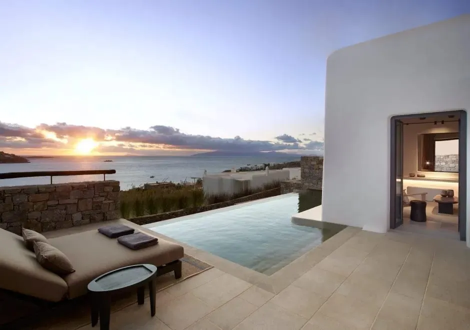 The Aloni Sunset Lounge at Kalesma Mykonos overlooking the island of Delos at dusk