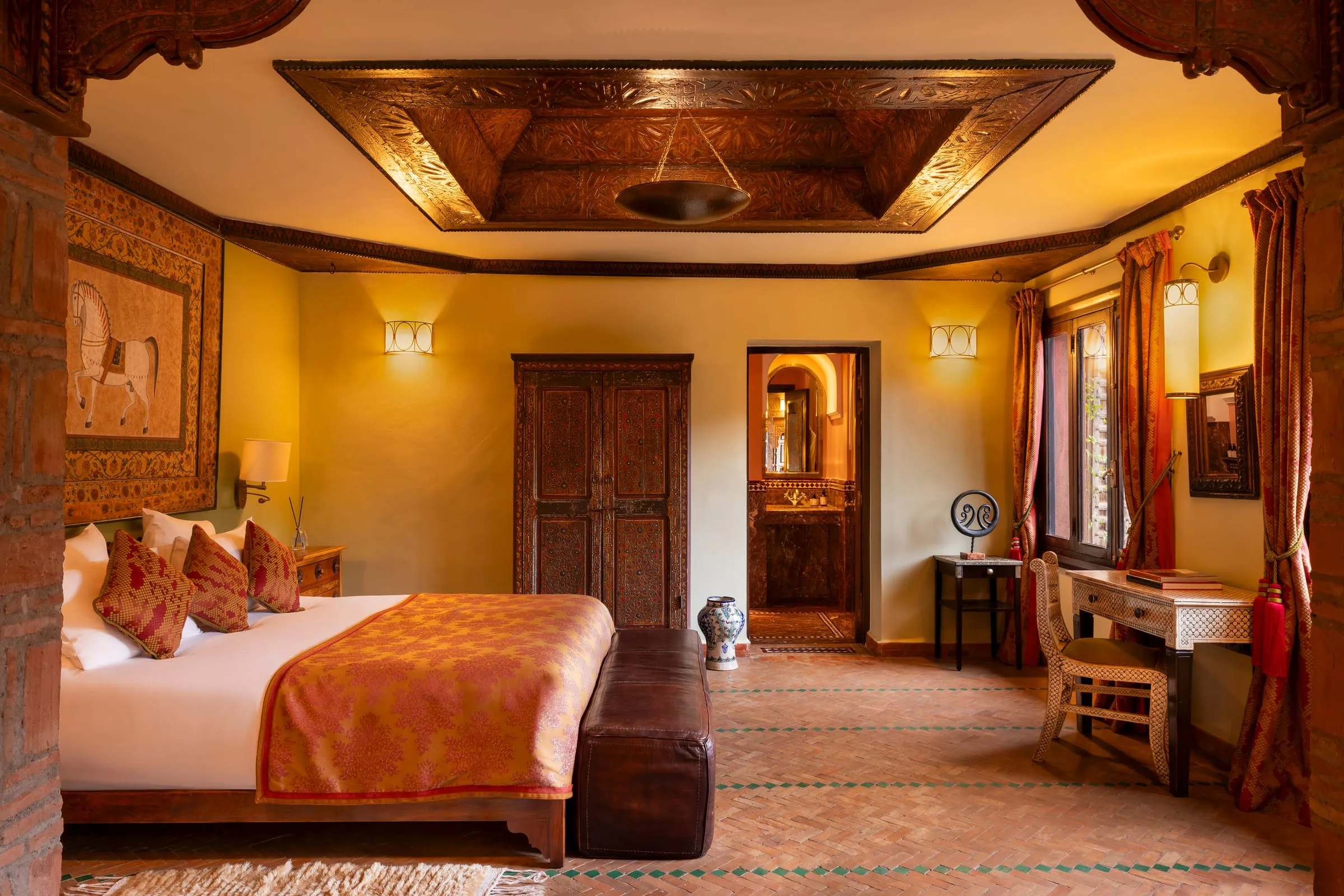 A tiled courtyard filled with Moroccan antiques and lanterns at Kasbah Tamadot