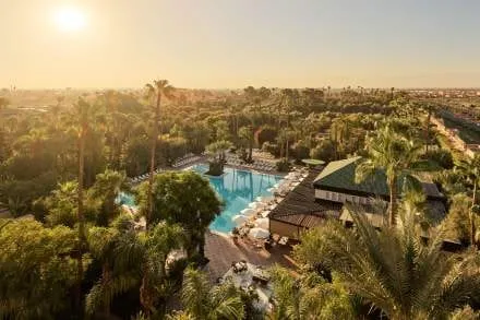 The facade of La Mamounia rising above its historic gardens on the edge of the Marrakech medina