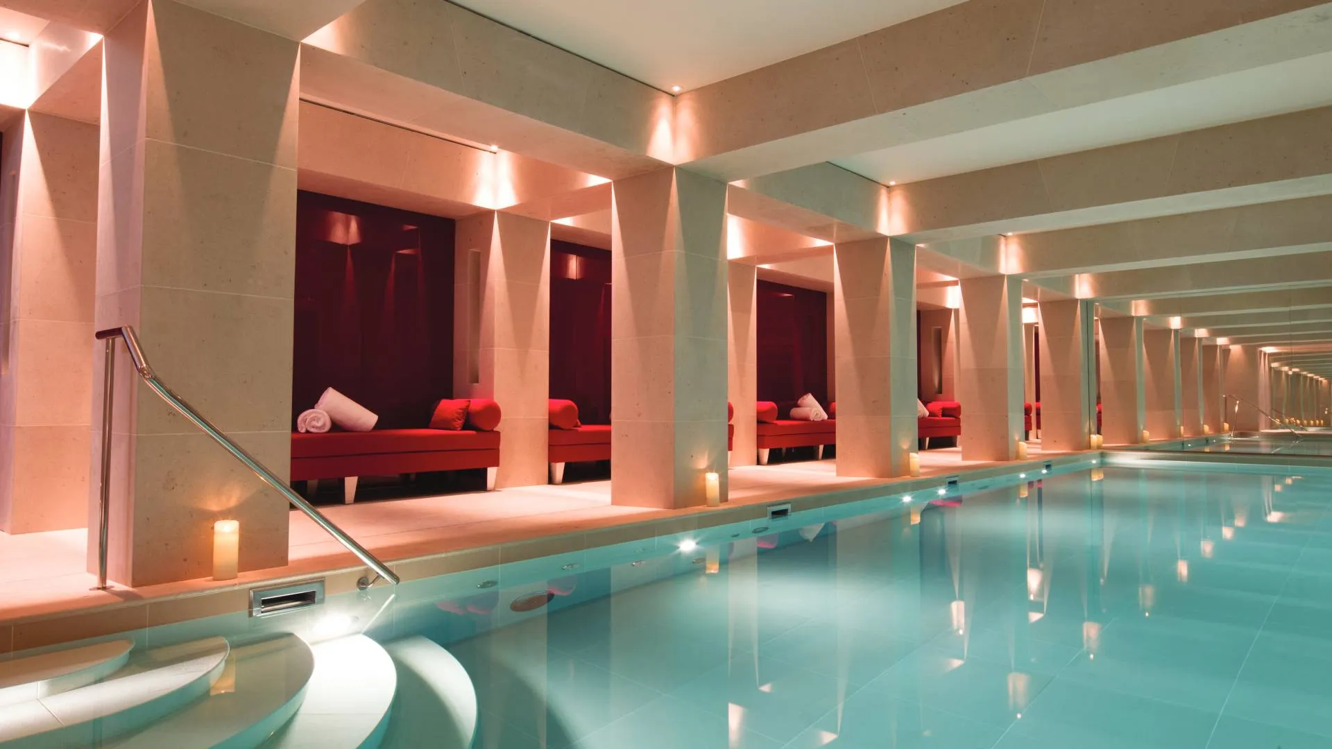 The indoor pool at the Nescens Spa at La Reserve Paris, lined in stone beneath a vaulted ceiling