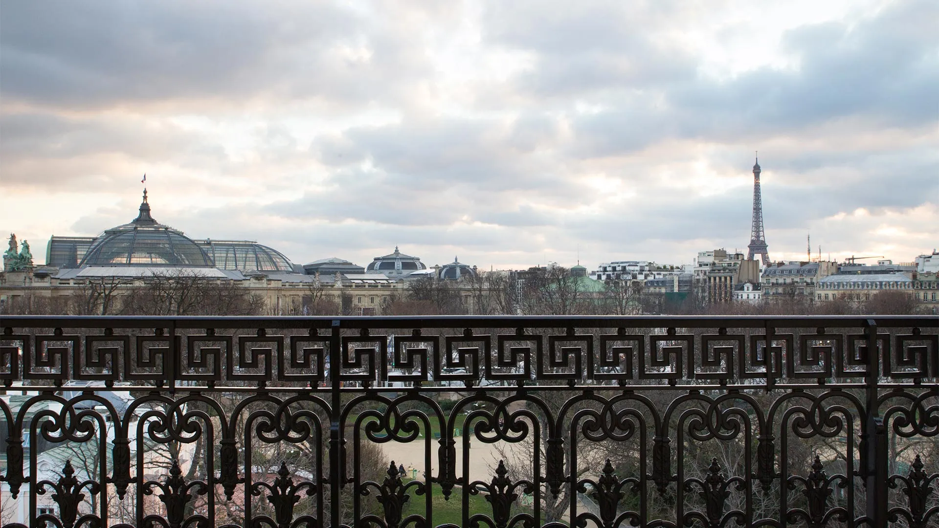 A quiet corner of Avenue Gabriel near La Reserve Paris, with the gardens of the Champs-Elysees and the Grand Palais visible in the distance