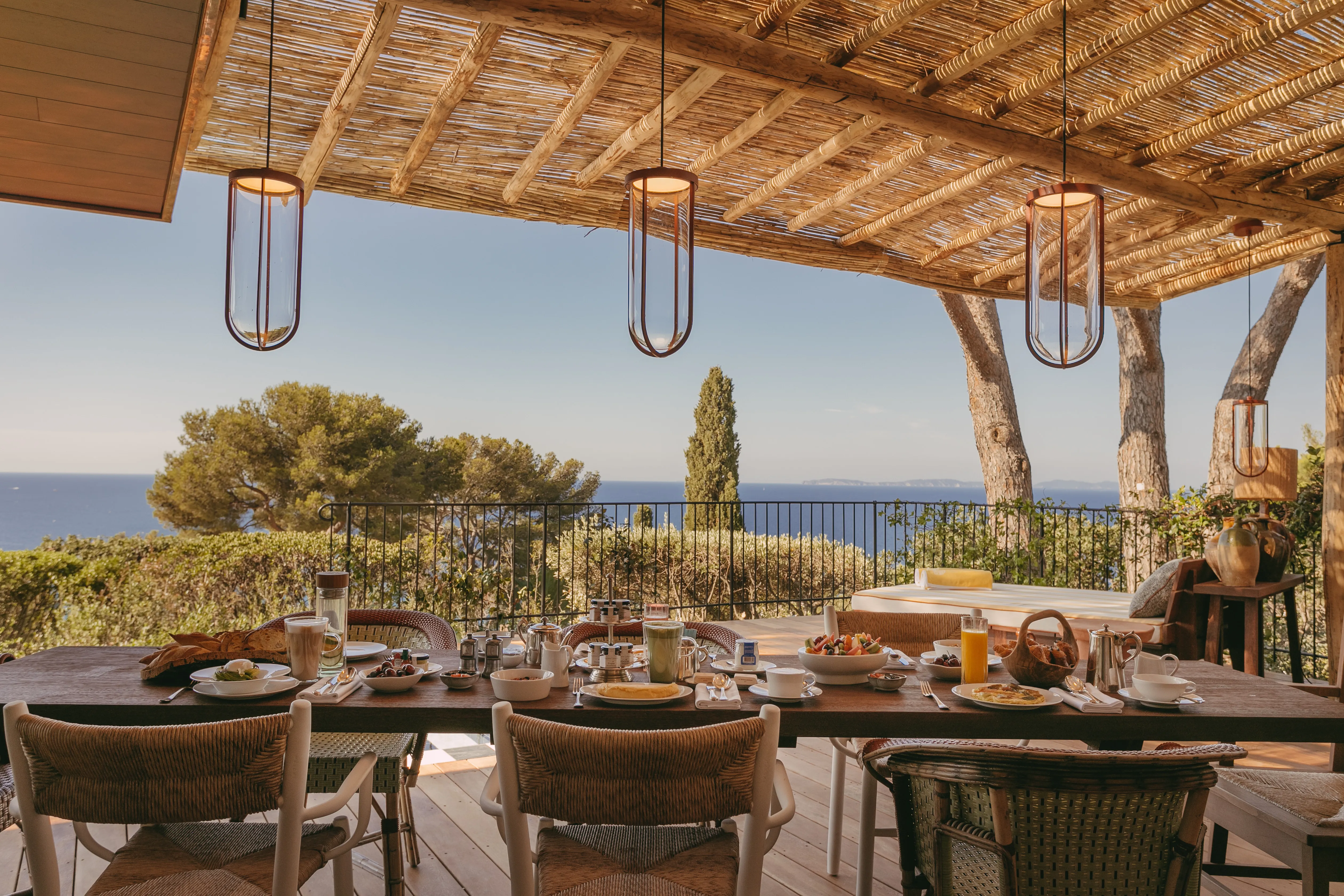 Vista restaurant's sea-facing terrace at dusk, tables set above the Golfe de Saint-Tropez
