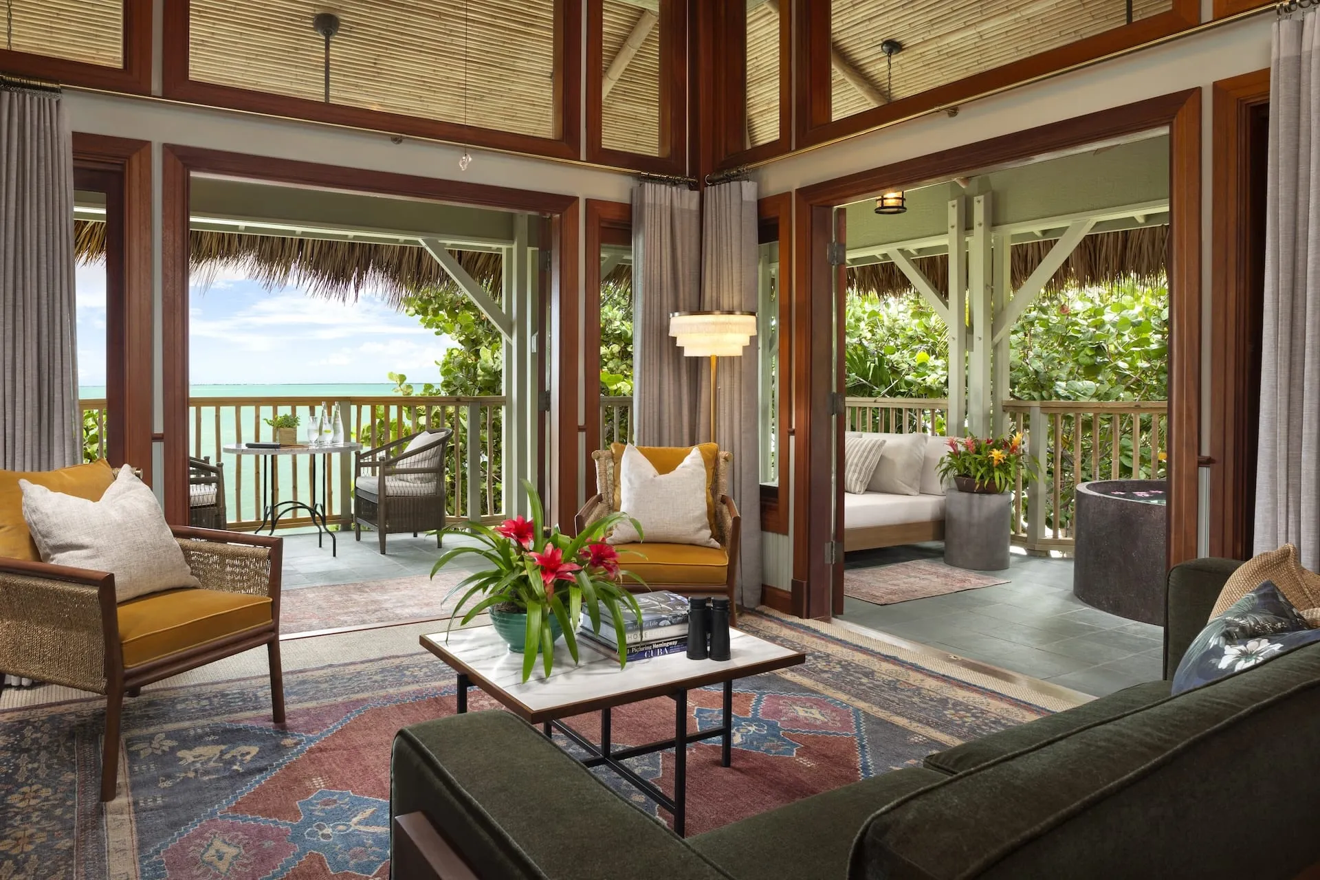 Crushed-shell path winding between thatched-roof bungalow suites at Little Palm Island