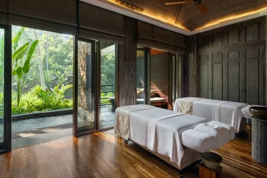 A treatment room at Mandapa Spa and Wellness Center opening onto the river valley