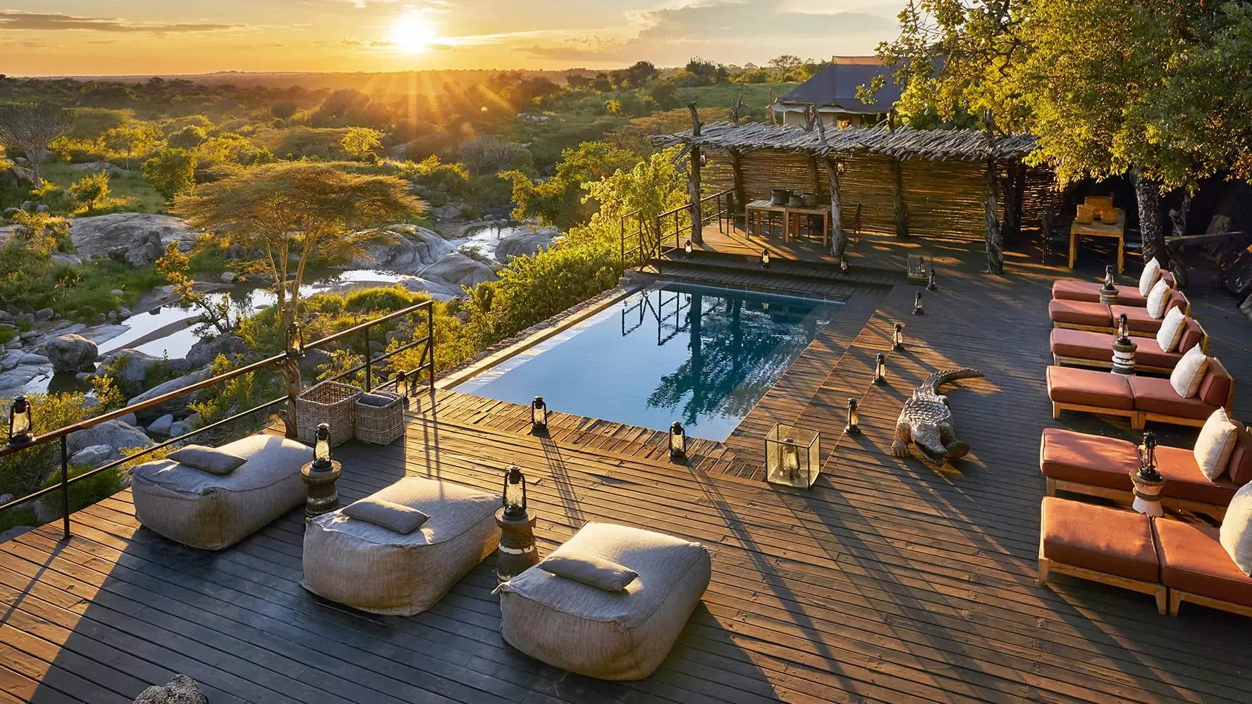 Stone-and-thatch suites at Mwiba Lodge built into a granite outcrop above the Arugusinyai River gorge in Tanzania's Mwiba Wildlife Reserve