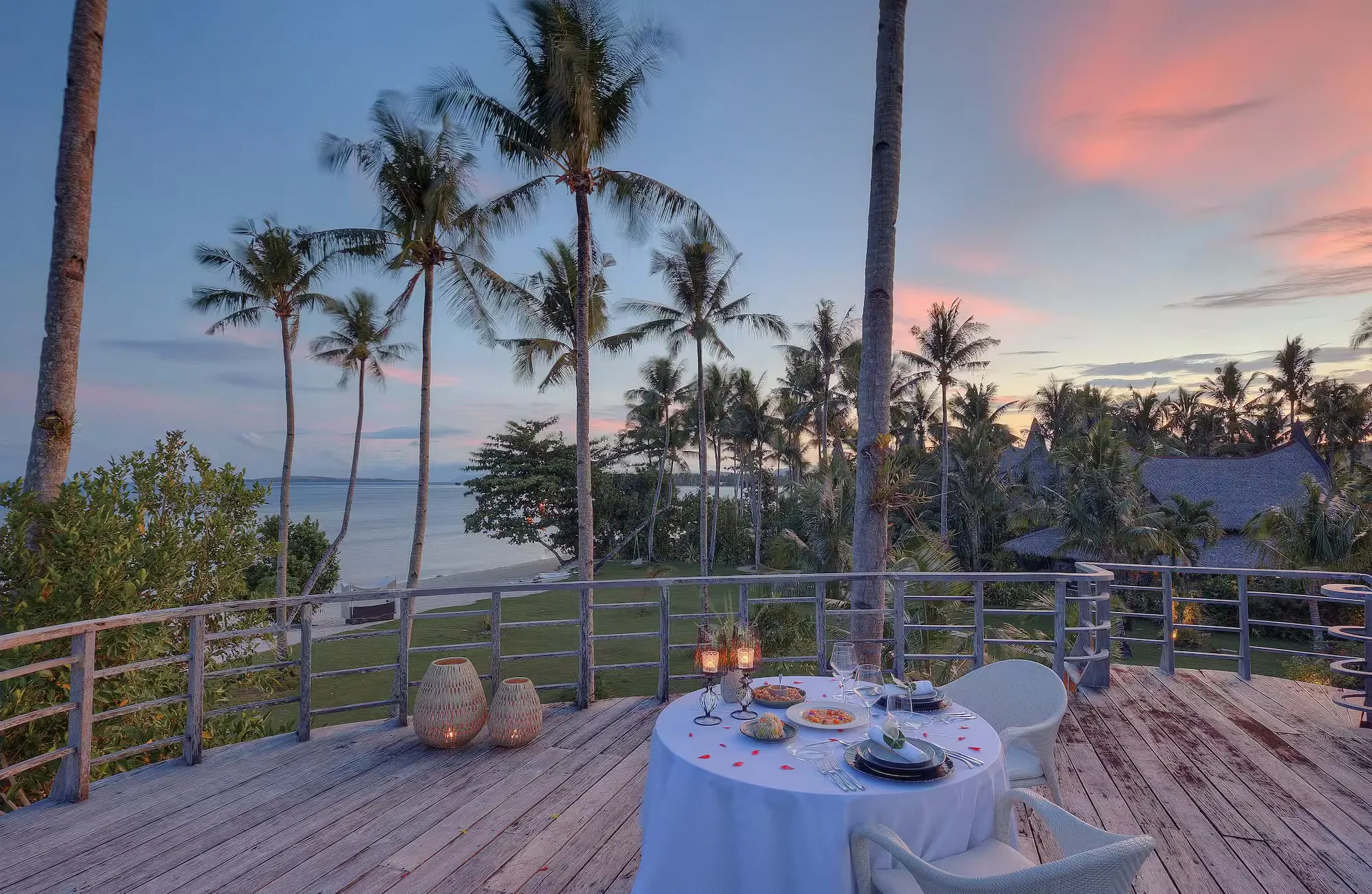 An open-air dining pavilion set for a private meal on the beach at Nay Palad Hideaway