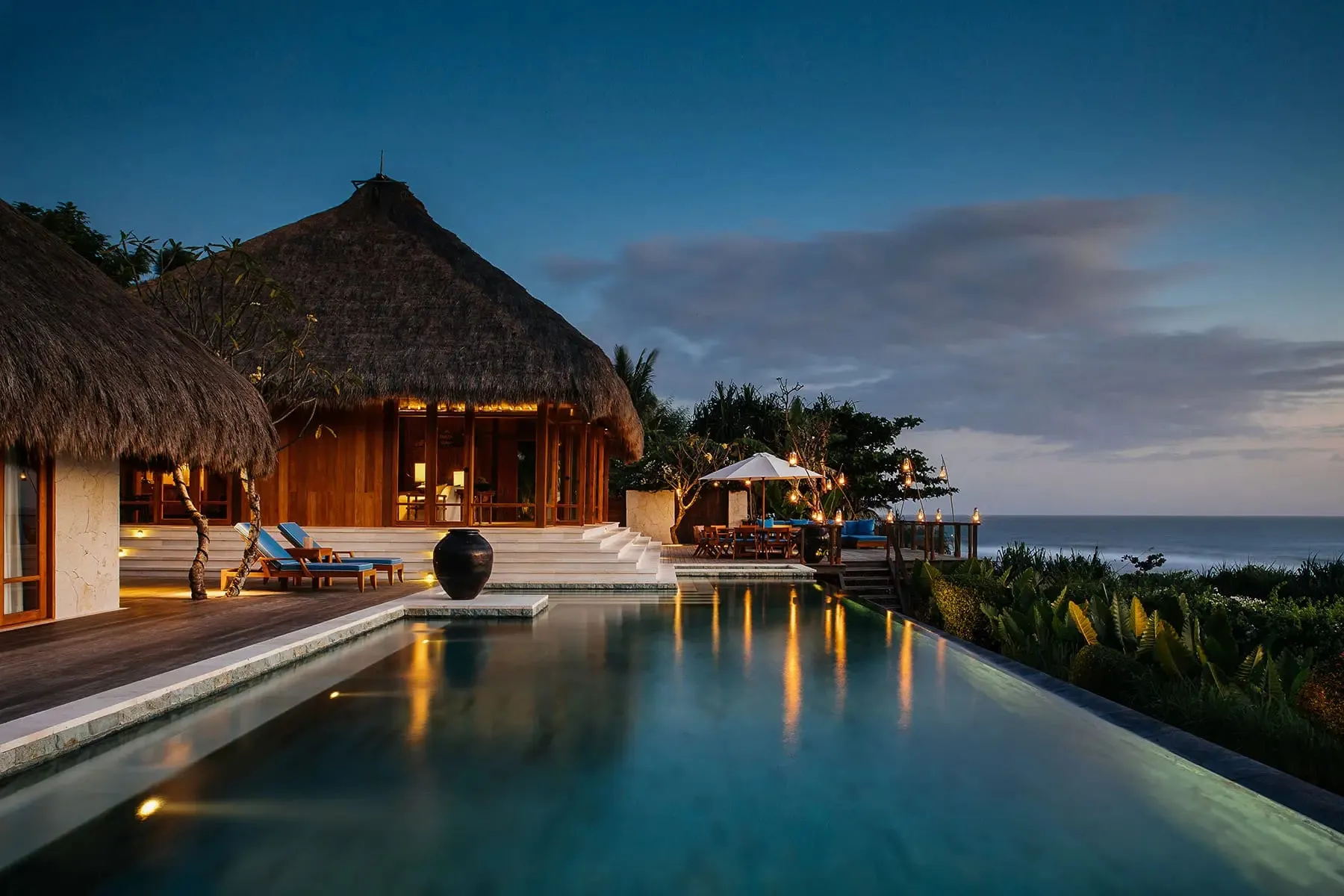 A thatched-roof villa with a private infinity pool set above the beach at NIHI Sumba