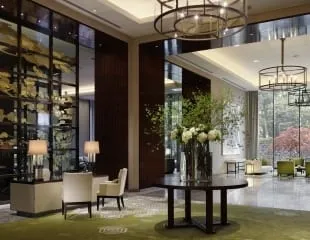 A suite interior at Palace Hotel Tokyo with grey marble and dark wood detailing