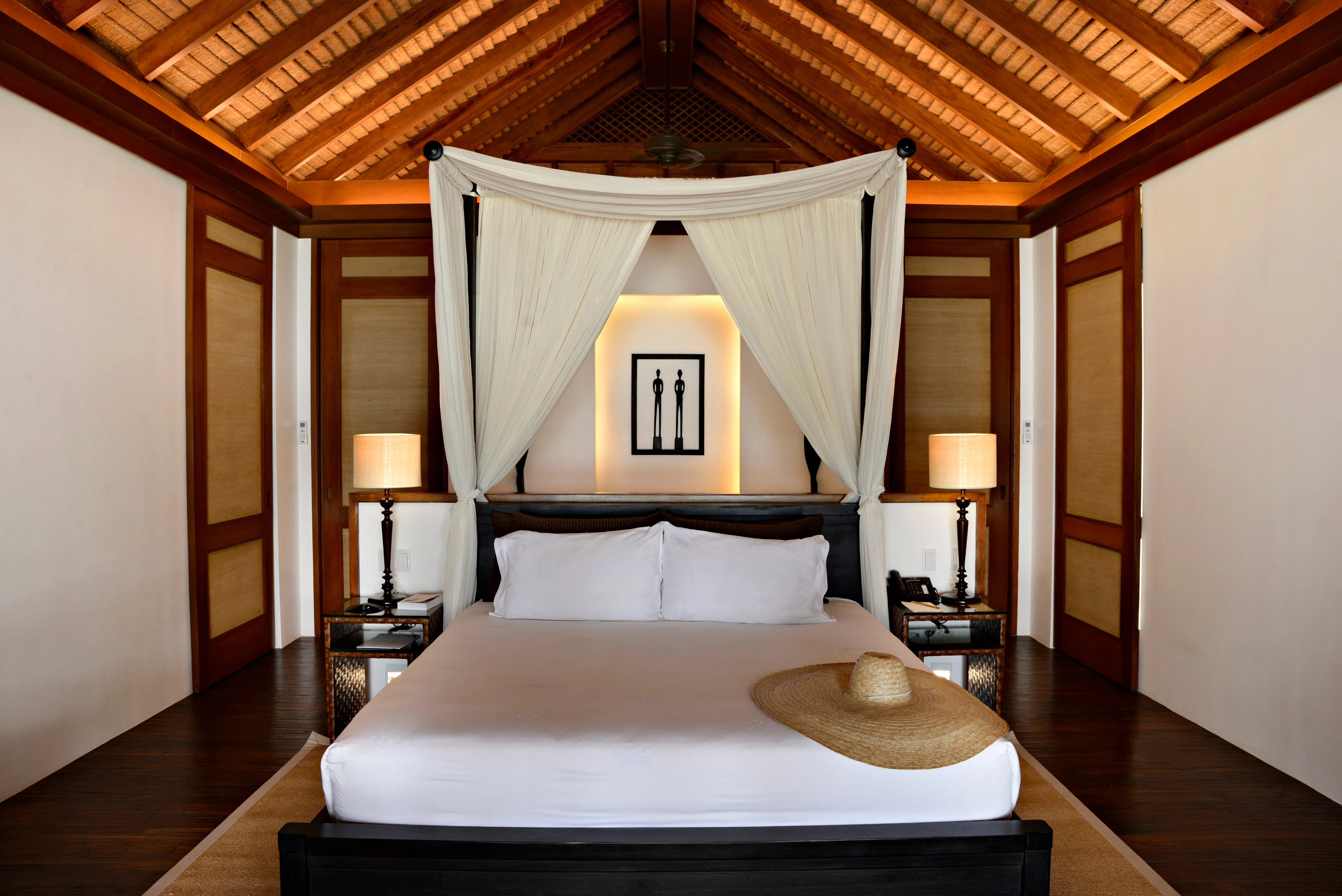 A Beach Villa at Pangulasian Island Resort set just behind the treeline, its private balcony facing the shore