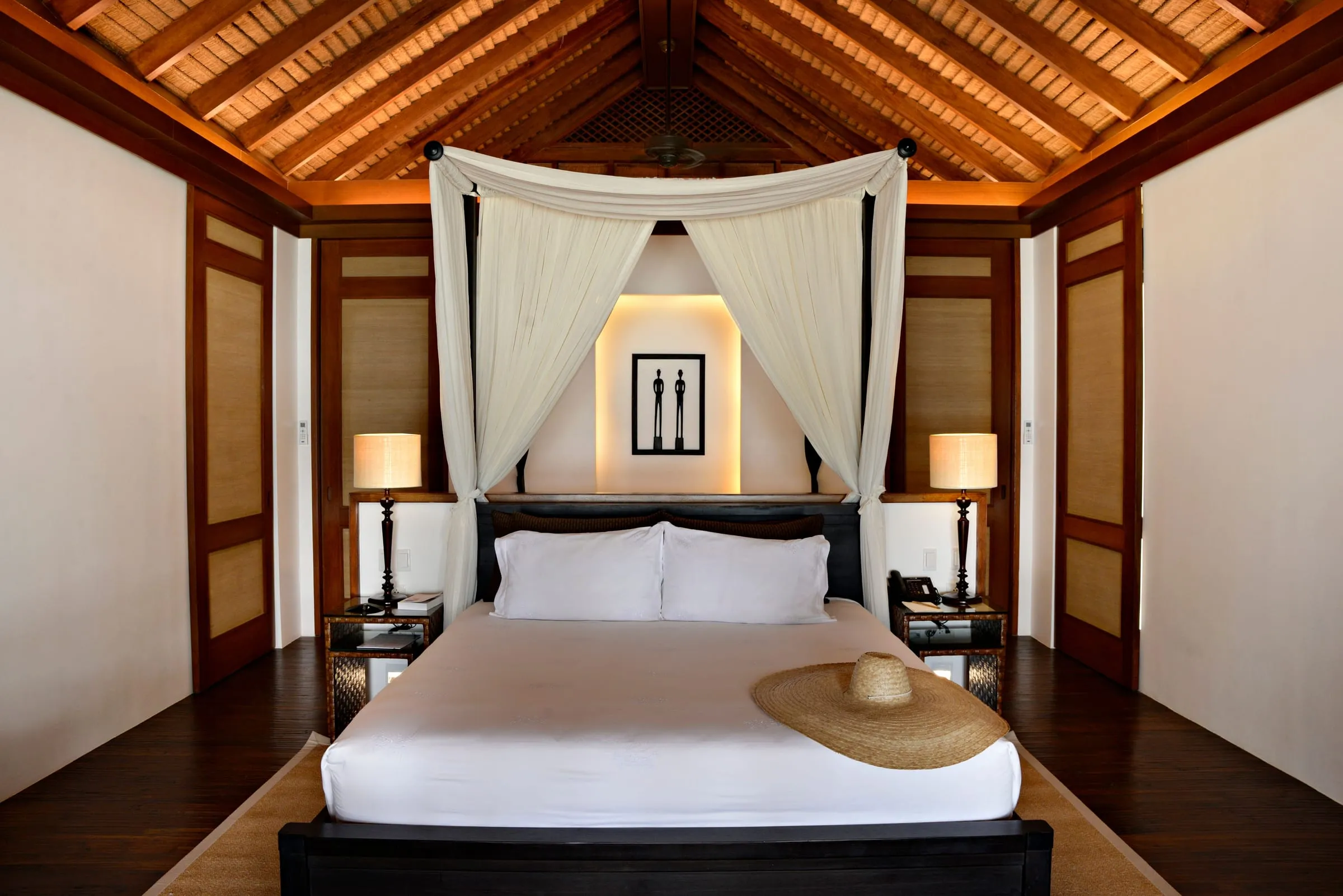 A Beach Villa at Pangulasian Island Resort set just behind the treeline, its private balcony facing the shore