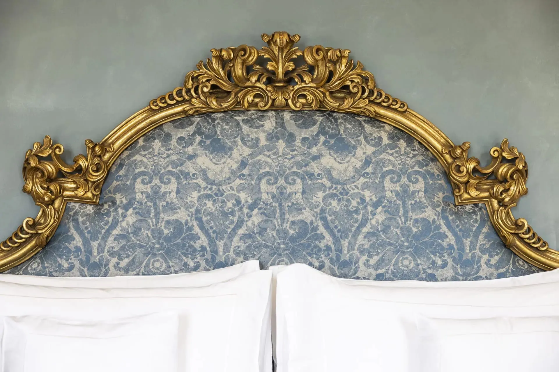 A suite interior at Passalacqua furnished with antiques, Fortuny lampshades, and Como silk curtains