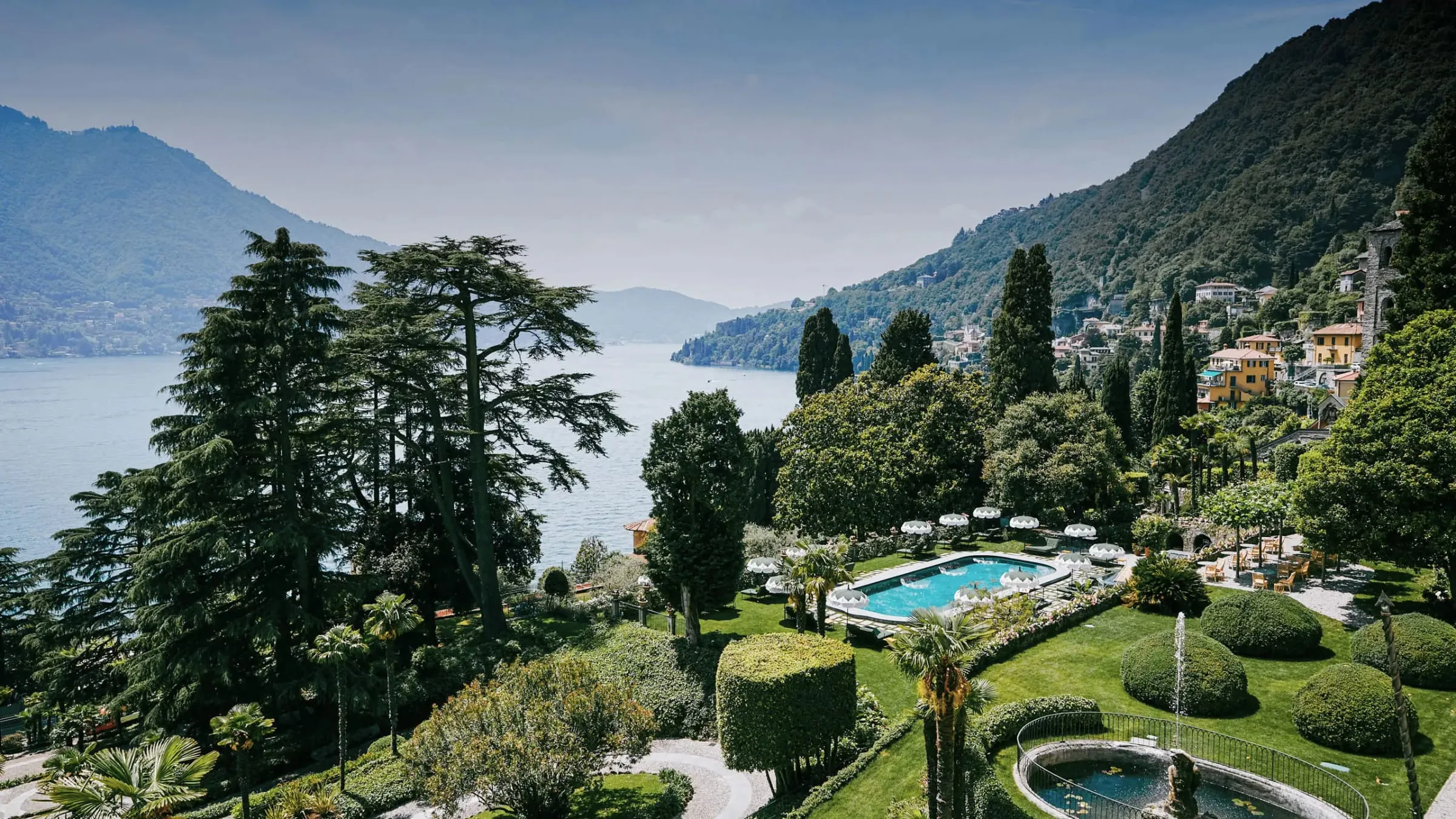 The neoclassical facade of Passalacqua rising above its terraced gardens on the shore of Lake Como near Moltrasio