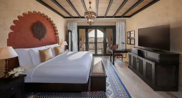 A private plunge pool on the deck of a pool villa at Qasr Al Sarab overlooking the dunes of the Empty Quarter