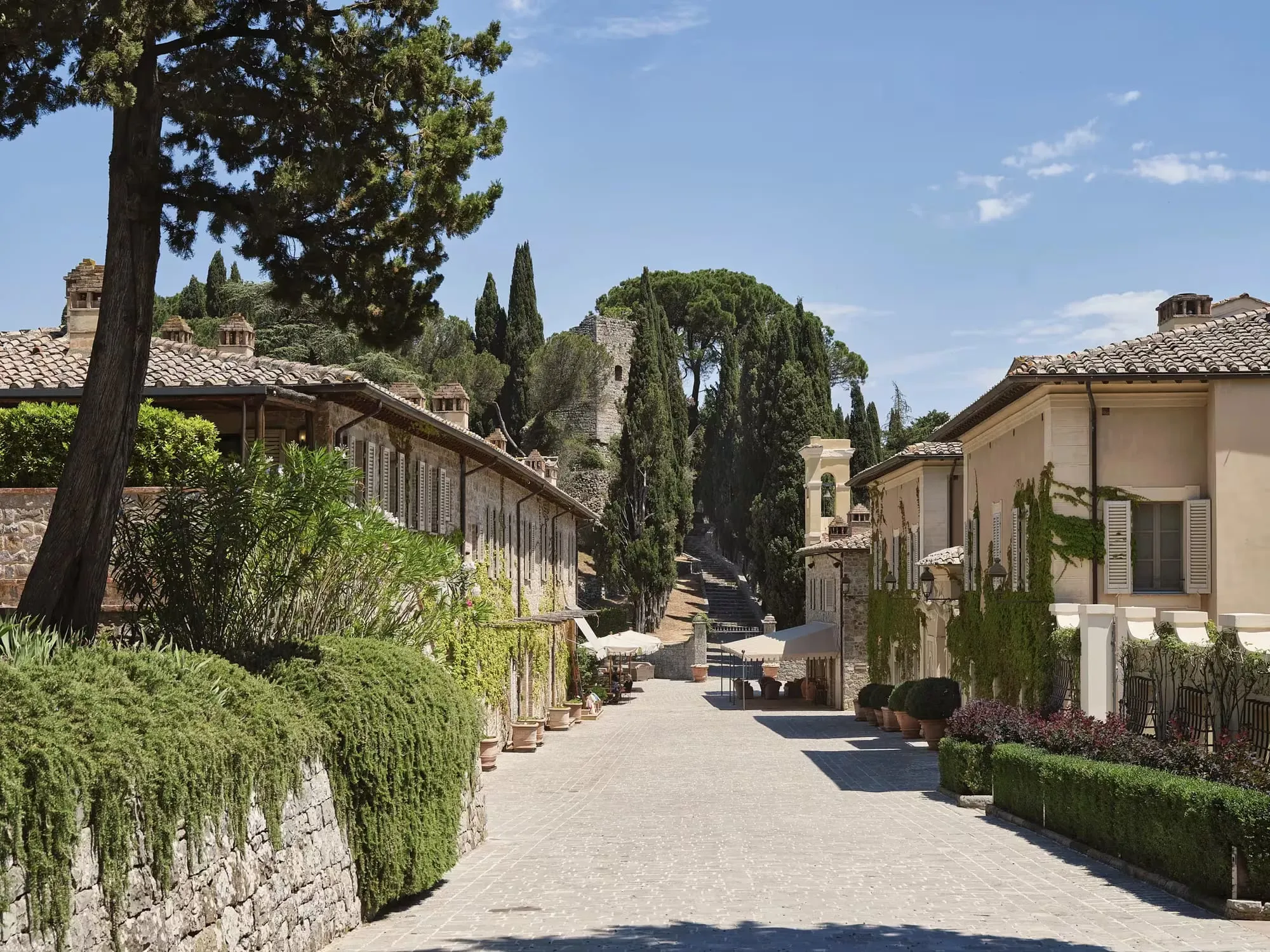 A suite at Rosewood Castiglion del Bosco with exposed wooden beams and antique Tuscan furnishings
