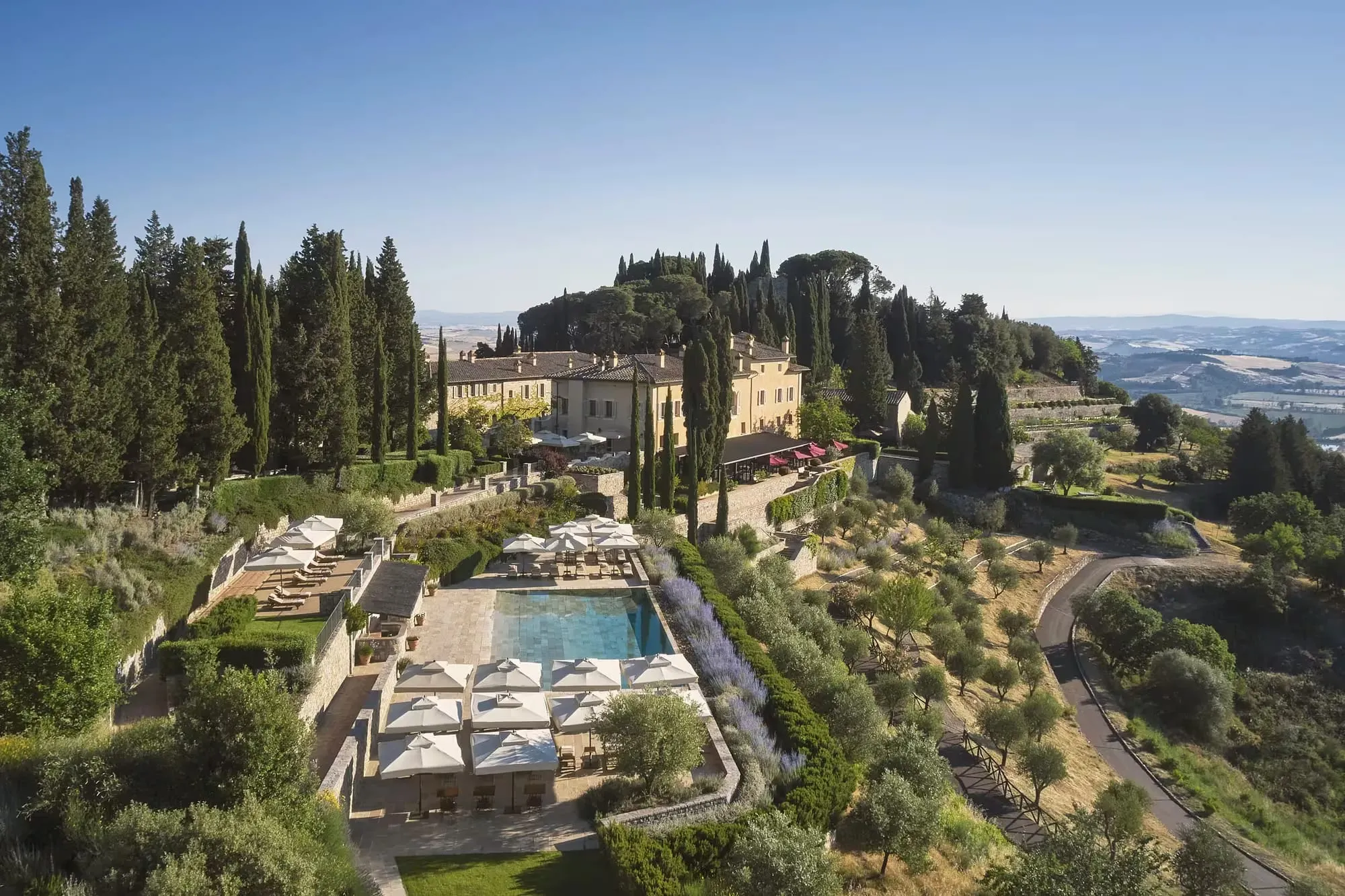 The medieval borgo of Rosewood Castiglion del Bosco rising above vineyards and cypress-lined hills in Tuscany's Val d'Orcia