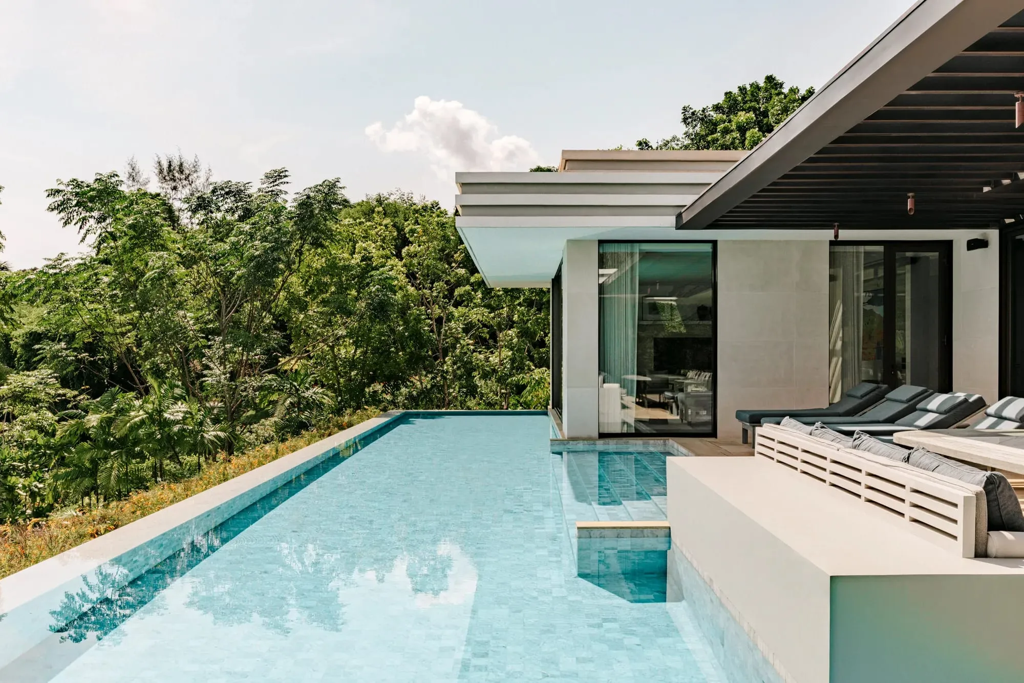 A Rosewood Phuket pool pavilion with floor-to-ceiling glass and a private plunge pool set among tropical planting