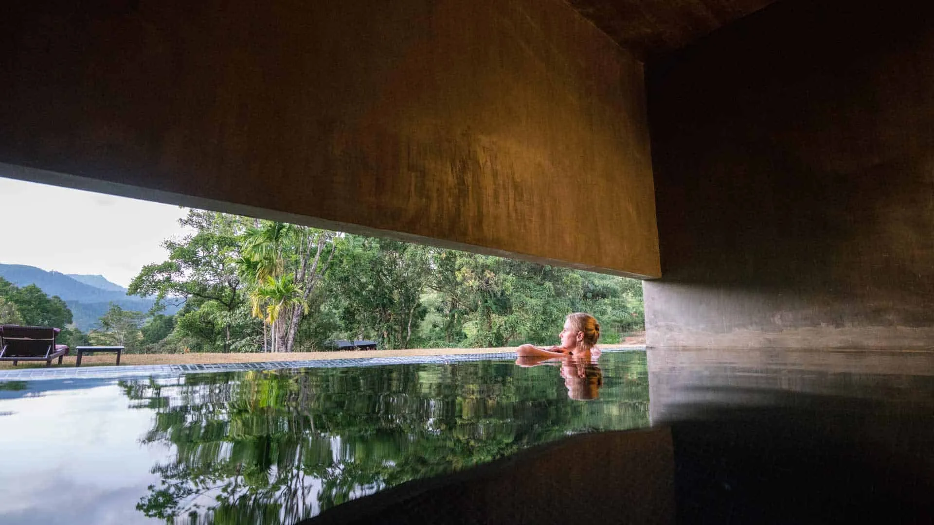 Open-sided yoga pavilion at sunrise above the tea plantation