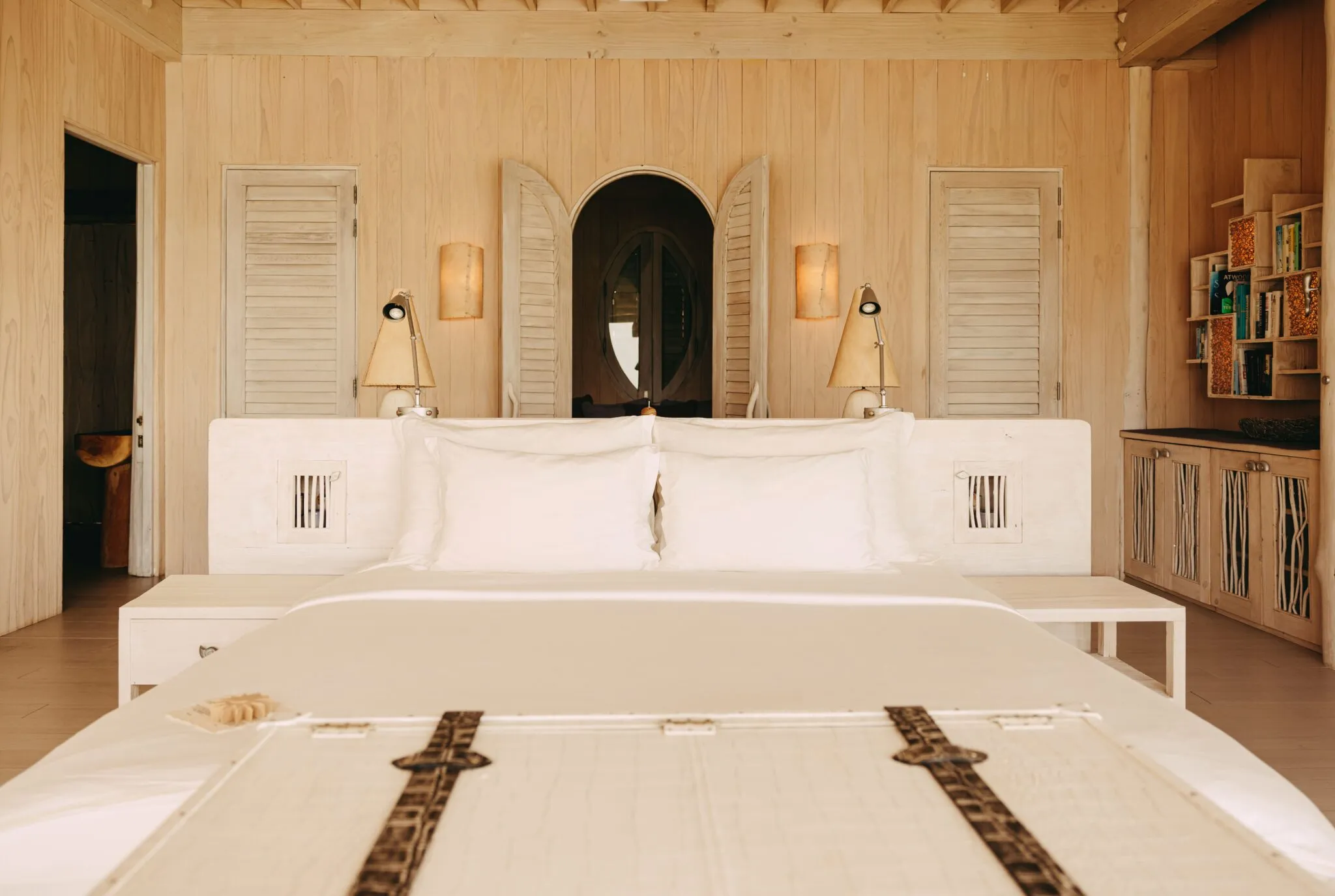 An overwater villa deck at Soneva Jani with a private plunge pool facing the open lagoon