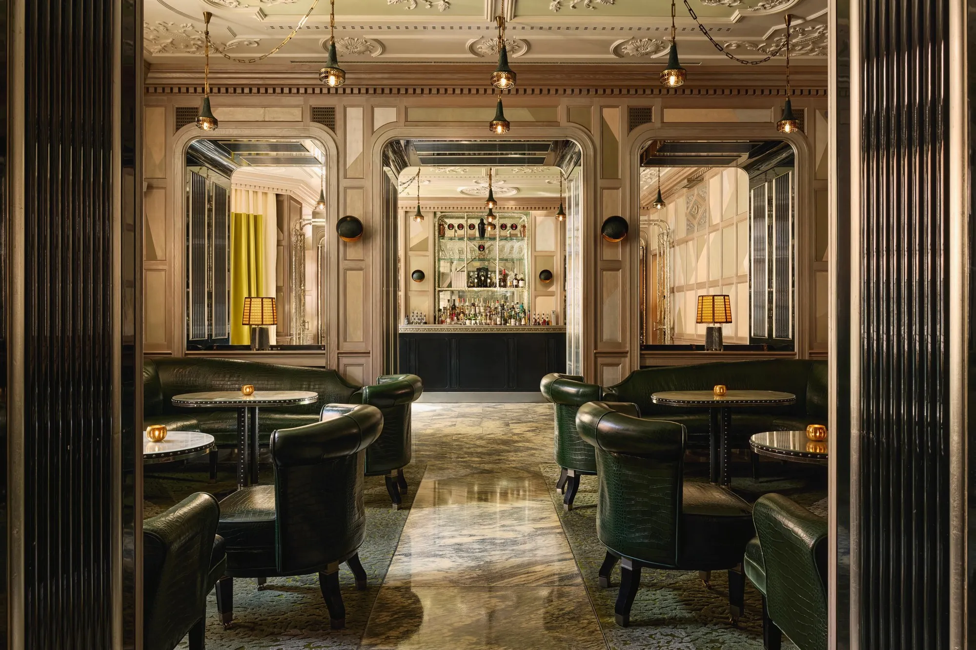 A guest suite at The Connaught with a canopied bed, antique furnishings and a window seat overlooking Mount Street